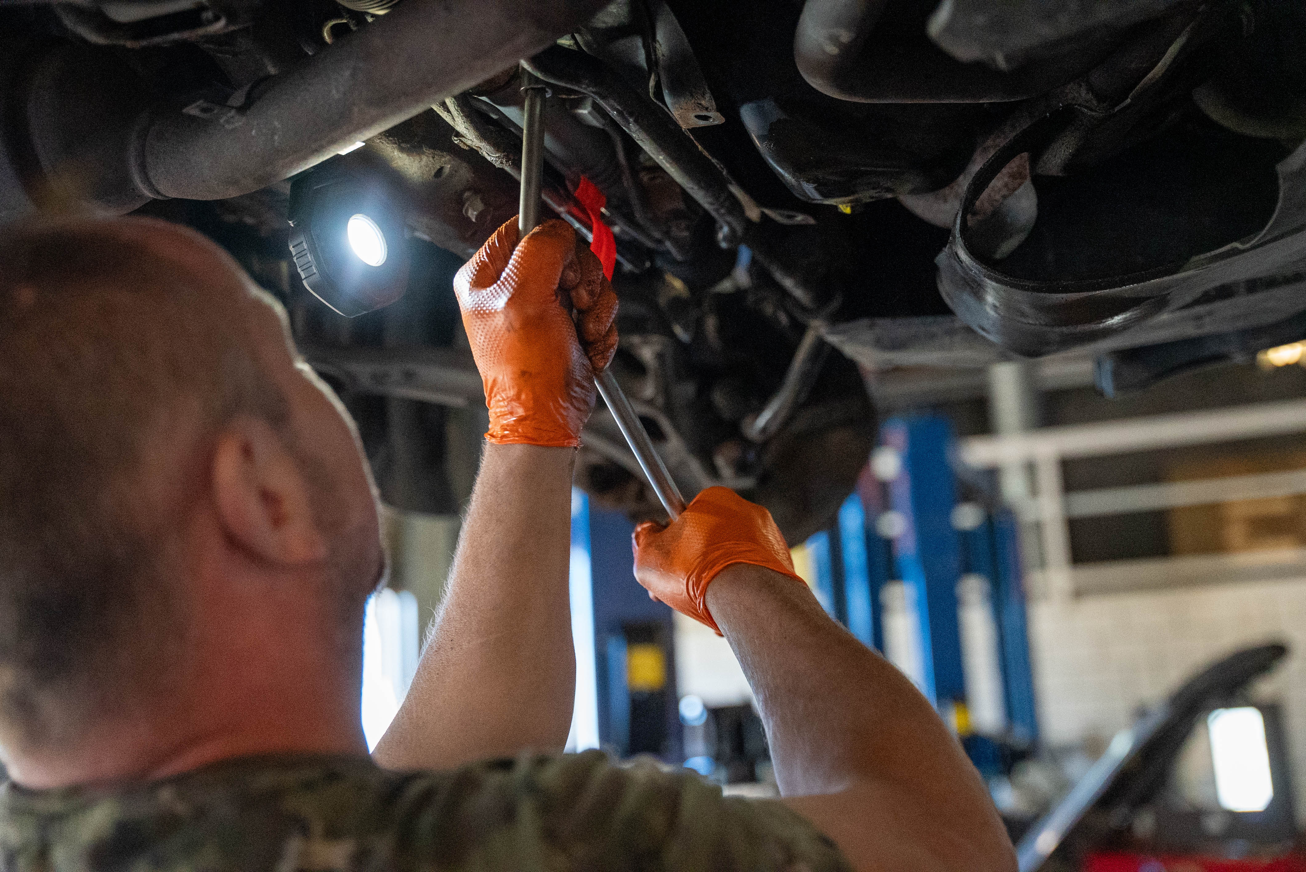 A Eurospec technician inspecting a vehicle from underneath