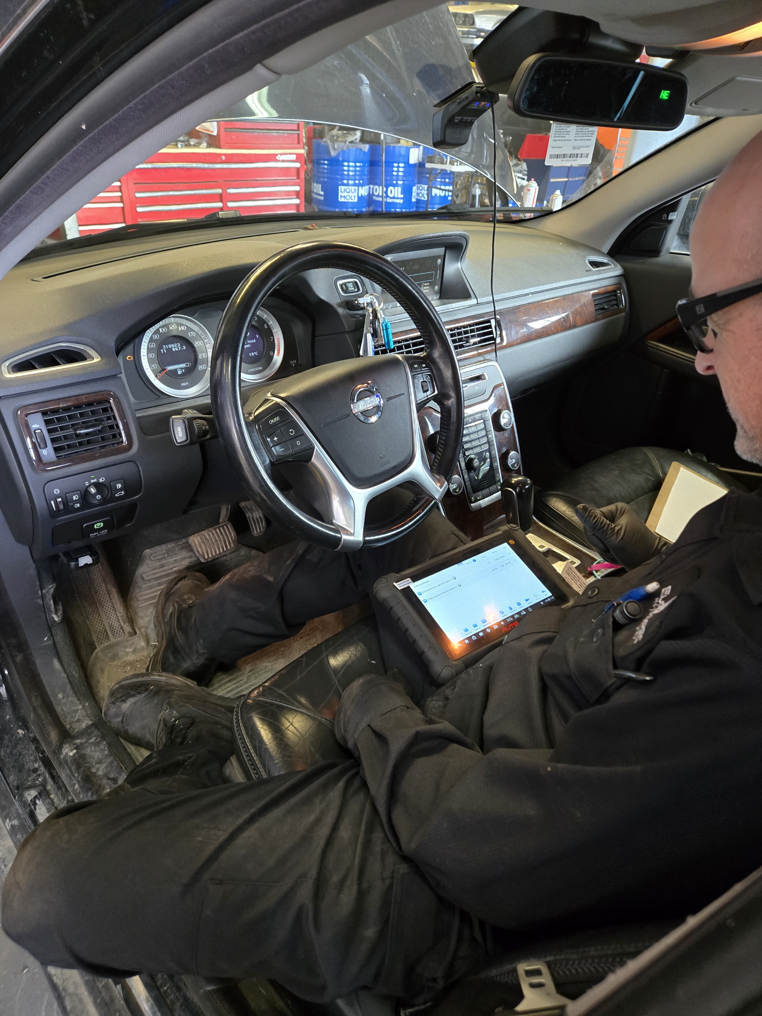 A Eurospec technician using diagnostic equipment inside a Volvo